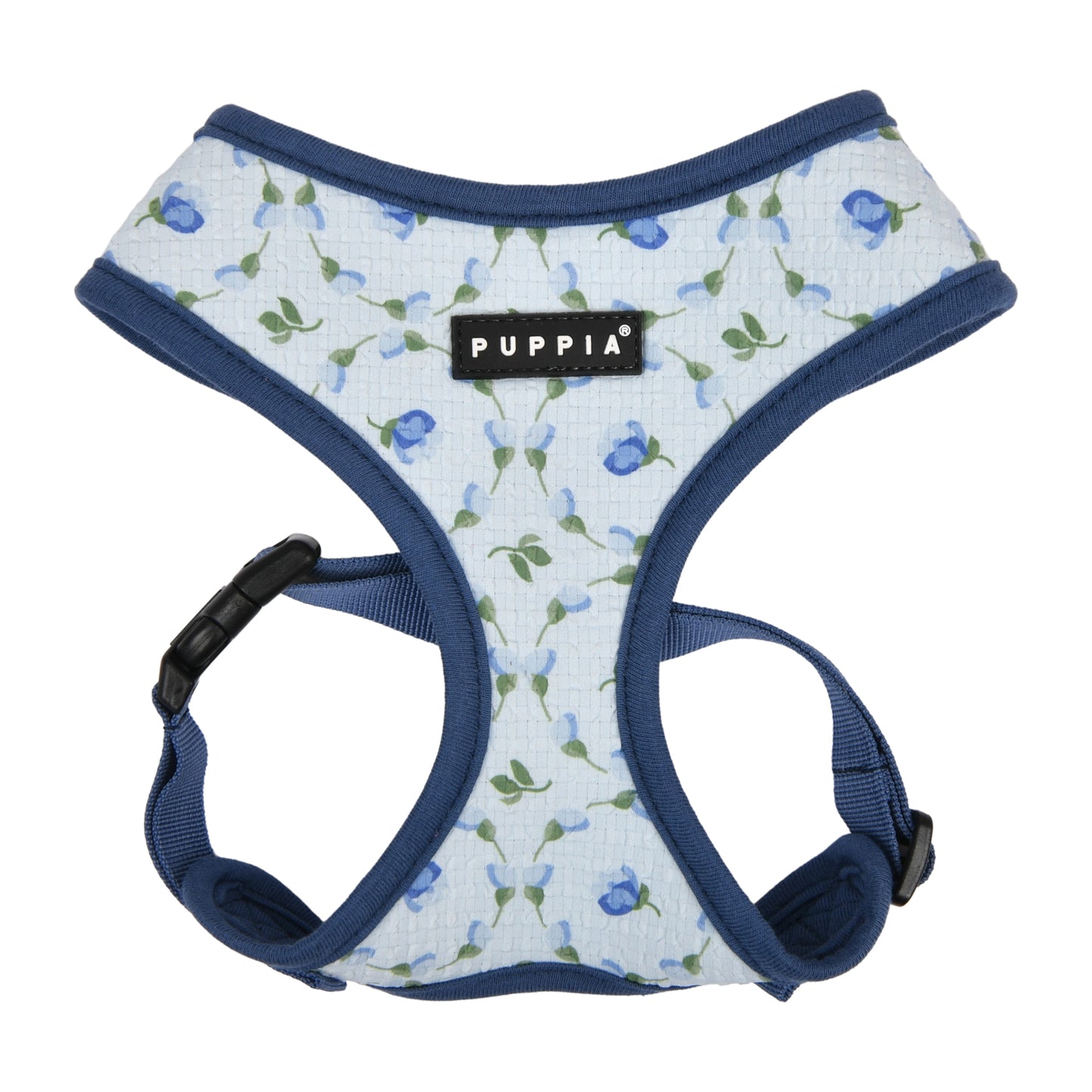 Primer plano del tejido suave del Arnés Florian de Puppia, con estampado floral colorido, perfecto para días cálidos.