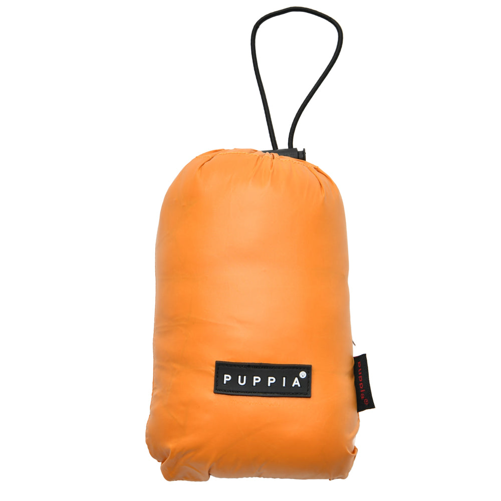 Chaqueta Ultralight A Puppia doblada y guardada en su bolsa compacta, perfecta para llevar de viaje o para espacios limitados.